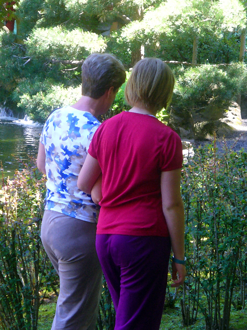 Women walk in park.